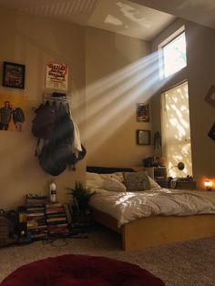 a bed room with a neatly made bed and sunlight streaming through the window over it