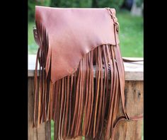 Rustic ranch bag with fringe. Our gorgeous fringe bag with detachable belt strap. This medium size handmade fringe handbag is perfect for everyday use. We use it as a large clutch bag, cosmetic/travel bag or a crossbody purse. Made with high-grade waxed vintage style full grain leather.fringe Leather will have markings and scratches that will change over time with use. Both inside and outside it has large pockets. Dimensions: height: 21 cm (6 in) max width: 27 cm (10.5 in) Crossbody leather stra Bohemian Fringe Satchel For Daily Use, Leather Satchel Bag With Fringe, Brown Artisan Bags With Fringe, Daily Use Brown Fringe Bag, Everyday Leather Fringe Satchel, Bohemian Crossbody Satchel With Fringe, Brown Bohemian Satchel With Fringe, Bohemian Fringe Crossbody Satchel, Bohemian Brown Fringe Satchel