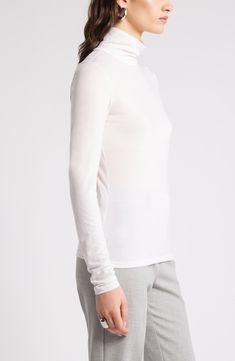 Lightweight, soft and warm, this trim turtleneck is also versatile, ensuring its place at the top of your rotation. Turtleneck Long sleeves 70% Tencel® lyocell, 30% wool Tencel lyocell is a more-sustainably produced fiber made with closed-loop processing Machine wash, tumble dry Imported White Fine Knit Turtleneck Top, Fine Knit Long Sleeve Mock Neck Top For Layering, Stretch Fine Knit Turtleneck For Layering, Elegant Turtleneck Long Sleeve Top For Layering, Elegant Long Sleeve Turtleneck Top For Layering, Versatile Fine Knit Turtleneck Top, Stretch Fine Knit Mock Neck Top For Layering, White Fine Knit Turtleneck With Funnel Neck, Long Sleeve Turtleneck With Minimal Stretch For Layering