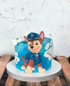 a blue cake with a dog on it