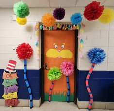 the dr seuss door decoration is decorated with pom poms and streamers