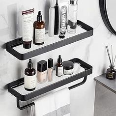 two black metal shelves holding different types of skin care products in front of a mirror