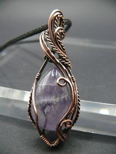 Handmade, one-of-a-kind amethyst gemstones wrapped in solid copper wire. Amethyst is considered a stone of peace. It is closely associated with both the third eye and the crown chakra. Amethyst is known for bringing a feeling of calm and clarity to our chaotic world. Those who keep Amethyst close may feel comforted, grounded, and soothed in a truly uplifting way. This beautiful gemstone is wrapped in oxidized copper to give it a vintage look, and polished to reveal the warm coppery tones beneath Wire Wrapping Gemstones, Wire Wrapped Amethyst Necklaces For Meditation, Amethyst Wire Wrapped Necklace For Meditation, Elegant Amethyst Necklace Hand Wrapped, Hand Wrapped Purple Copper Jewelry, Elegant Hand Wrapped Amethyst Necklace, Artisan Amethyst Wire Wrapped Necklaces, Unique Amethyst Wire Wrapped Necklaces, Unique Wire Wrapped Amethyst Necklaces