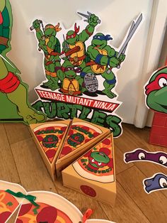 teenage mutant ninja turtles pizza cutouts and stickers are on the floor in front of an open refrigerator