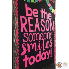 a sign that says be the reason someone smiles today