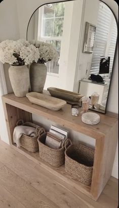 a mirror and some baskets on a shelf