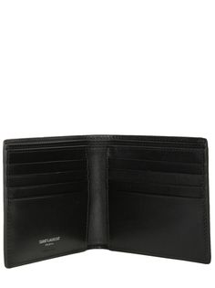 Saint Laurent's billfold wallet crafted in black smooth leather adorned with the unmistakable tonal metal interlocking YSL signature. Fabric-lined interior with two notes compartments, two slip pockets and eight card slots.Gender: MENMaterial: 100% CALF SKINColor: BLACKMade in: ITProduct ID: 4532760SX0E1000*Import tax/duty will be calculated at checkout (If applicable) Designer Business Trifold Wallet, Modern Black Wallet With Logo Plaque, Modern Bifold Wallet With Logo Plaque, Modern Leather Wallets With Logo Plaque, Designer Trifold Wallet With Coin Pocket For Business, Designer Trifold Wallet With Interior Card Slots For Business, Designer Trifold Wallet With Rfid Blocking For Business, Designer Trifold Wallet With Interior Card Slots, Designer Bifold Wallet With Rfid Blocking