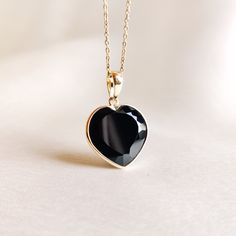 This stunning heart pendant is set in 14K Solid Yellow Gold with Natural Black Onyx with utmost precision. It is an unique gemstone pendant for nearly every occasion and is completely hassle-free jewelry. 🔷ABOUT GEMSTONE:  Black onyx is often considered a protective stone. It is believed to absorb and transform negative energies, preventing them from affecting the wearer. Black onyx is associated with strength, both physical and emotional. It is believed to provide inner strength, resilience, a Black Onyx Jewelry, Gold Heart Pendant, Handmade Jewelry Box, Onyx Jewelry, Bezel Pendant, Yellow Gold Pendants, December Birthstone, Unique Gemstones, Inner Strength