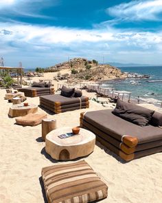 an outdoor seating area on the beach near the ocean