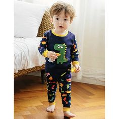 DESCRIPTION These fun, comfortable cotton pajamas make the perfect addition to any jammie collection. These jammies are 100% cotton, soft and comfortable for your little dinosaur lover. Pants are pull-on with wide elastic waist band, and the top and pants are ribbed at the waist and cuffs. Both also have a tagless label for your child's comfort. The fit is super snug so you may need to go up a size or if your child is on the cusp of going up a size soon, you may want to go up two sizes. DETAILS Fun Cotton Loungewear Set, Fun Cartoon Print Sleepwear For Bedtime, Fun Cartoon Print Sleepwear, Cotton Long Sleeve Dinosaur Print Set, Cotton Long Sleeve Sets With Dinosaur Print, Fun Cartoon Print Sleepwear For Loungewear, Family Matching Cartoon Print Sleepwear, Fun Cotton Sleepwear Set, Fun Cotton Sleep Sets