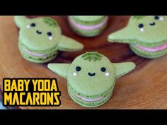 baby yoda macarons are sitting on a wooden table with the caption'baby yoda macaroons '