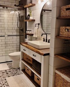 a bathroom with a sink, toilet and shelves in the shower area next to it