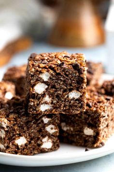 several pieces of brownie on a white plate