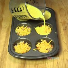 someone is pouring cheese into the muffin tins