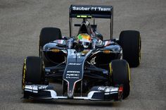 a black and white race car driving on a track