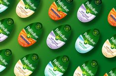 many different colored discs are arranged on a green surface with the words palmolive printed on them