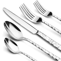 four forks, two spoons and one knife on a white surface