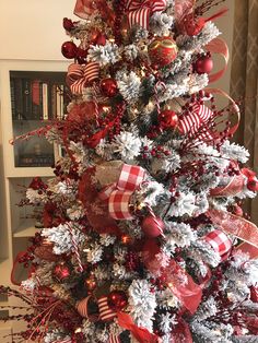 a decorated christmas tree with red and white ornaments