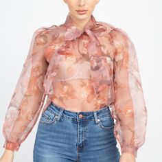 Semi Sheer Floral Organza Tunic Blouse With Tie Neck. Long Balloon Sleeves. 100% Polyester. Chic Floral Print Tops For Party, Chic Pink Blouse For Fall, Chic Pink Fall Blouse, Chic Fitted Rose Print Blouse, Chic Fitted Blouse With Rose Print, Spring Sheer Pink Blouse, Pink Sheer Blouse For Spring, Sheer Pink Blouse For Spring, Fitted Floral Print Peach Tops