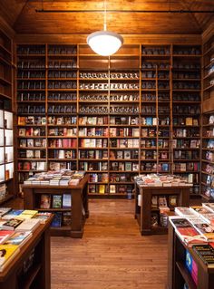 the inside of a book store filled with lots of books on shelves and wooden floors