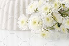 some white flowers are sitting on the table and it looks like they have been taken off