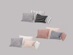 four different colored pillows on a gray background, one is black and the other is white