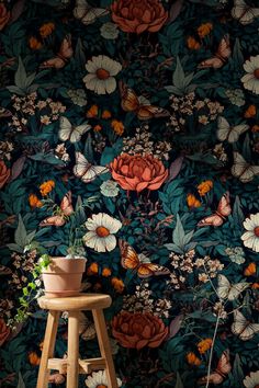 a flower wallpaper with flowers and butterflies on the wall next to a wooden stool