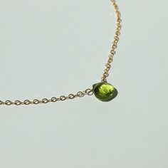 "A vibrant green peridot is suspended by dainty chain. Available in 14k gold filled and sterling silver. (Peridot is August's birthstone!) This necklace is made of high quality materials. We only use 14k gold filled and sterling silver which (unlike plate) will not wear off after multiple wears. All of our silver is Argentium sterling silver, which is a higher quality version of sterling silver that is tarnish resistant and nickel free. Blue Aquamarine Short Pendant will arrive in a gift box. ・M Green Peridot Necklace For May Birthstone, Lime Green Peridot Necklace For May Birthstone, Green Peridot Gemstone Necklace, Green Peridot Pendant Necklace, Lime Green Necklace For May Birthstone Gift, Lime Green Necklace Gift For May Birthstone, Green Birthstone Necklace With Delicate Chain For May, Green Birthstone Necklace For May With Delicate Chain, Green Cable Chain Necklace For Gift