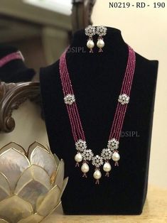 Pretty floral designer long mala/ designer necklace / ad jewelery/ kundan jewelery/ long necklace / punjabi jewellery / pakistani jewelry Beautiful long necklace made in real onex beads with pretty floral design in faux american diamond paired with cute earrings. Beads used in necklace is real onex crystal beads glass made NO PLASTIC Easy to wear, Light in weight & gives you a classy Look. It can be wear in festival occasion with matching salwar suit, saree or any traditional  Polki,AD Diamond N Luxury Temple Jewelry Necklace With Dangling Beads, Long Moti Necklace, Punjabi Jewellery, Beautiful Beaded Necklaces, Black Beads Mangalsutra Design, Fancy Jewelry Necklace, Pearl Necklace Designs, Diamond Necklace Designs, Beaded Necklace Designs