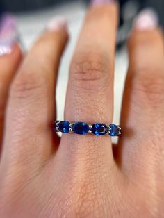 "Details: * Handmade item *Materials: 14k White Gold/ Natural Blue Sapphire Gemstone *Natural Gemstone: Blue Sapphire *Gem color: Royal Blue *Band color: White Gold *Condition: Never been Used; Made to order DESCRIPTION: 💎 Welcome to the Our Shop, Congratulations 🍾 on discovering us. 💎 The Royal Blue Sapphire eternity band from our \"Gem Candy Collection\" is a breathtaking display of elegant design and high-quality gemstones. The quality of the material is second to none and the stones are o Oval Eternity Band As A Gift, Formal Oval Sapphire Stackable Ring, Oval Eternity Band With Prong Setting For Promise, Blue Oval Stackable Rings, Classic Oval Sapphire Stackable Ring, Oval Gemstone Eternity Band For Promise Ring, Classic Oval Stackable Sapphire Ring, Gem Candy, Blue Sapphire Eternity Band