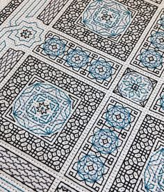 an intricately designed tile with blue and white designs on it's sides, in the middle of a floor