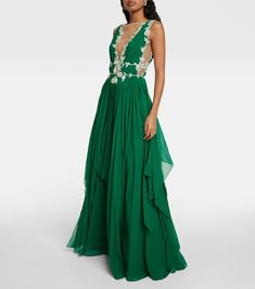 a woman in a long green dress