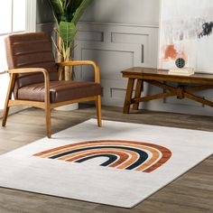 a chair and table in a room with a rug on the floor next to it