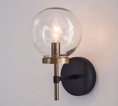 a wall light with a glass ball on it