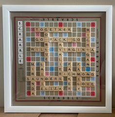 a framed scrabble puzzle with words written on it