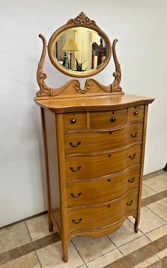 an antique dresser with a mirror on top