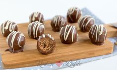 chocolate covered candies on a wooden cutting board