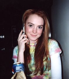 a young woman is talking on her cell phone