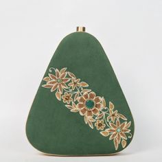 Elevate your evening ensemble with our "Enchanted Forest" Egg-Shaped Velvet Clutch, a masterpiece of artistry and elegance. Crafted from luxurious bottle green velvet, this clutch is a symphony of texture and color. The intricate embroidery, expertly done with onyx, garnet, and tiger eye gemstones, forms a mesmerizing pattern reminiscent of an enchanted forest. Size(cm): 20*18*4 Material: Velvet Fabric & Metal Thread Stones: Onyx, Garnet & Tiger Eye Base Color: Bottle Green Pockets: Single Each gemstone is carefully chosen not only for its aesthetic appeal but also for its unique energy and symbolism. The black onyx represents protection and strength, while the fiery red garnet symbolizes love and passion. Tiger eye adds a touch of grounding and confidence to the mix. The clutch's egg shap Formal Bollywood Style Embroidered Fabric, Elegant Hand Embellished Embroidered Fabric For Festive Season, Elegant Hand Embellished Embroidered Fabric For Festive, Elegant Hand-embellished Embroidered Fabric For Festive, Festive Green Embellished Embroidered Fabric, Green Floral Embroidered Fabric For Reception, Floral Embroidered Green Fabric For Reception, Traditional Floral Embroidered Evening Fabric, Traditional Floral Embroidered Fabric For Evening