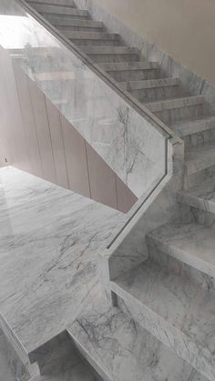 marble steps leading up to the top of a staircase in a building with no people