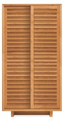 a wooden cabinet with shutters on the doors