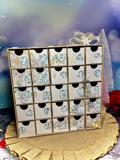 the twelve boxes have numbers on them and are decorated with snowflakes, ribbons and bows