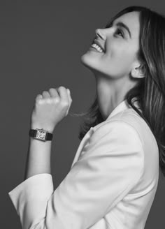 a black and white photo of a woman wearing a watch