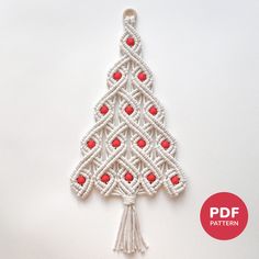 a crocheted christmas tree ornament with red beads