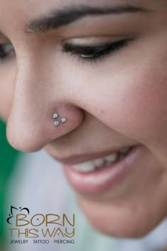 a close up of a woman with a nose piercing