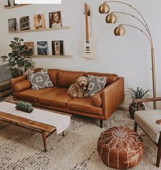 a living room filled with lots of furniture and pictures on the wall above it's couches