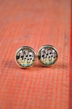 These sheet music earrings are perfect gifts for musicians and music teachers alike! This design feature a sheet music like design and shows many different types of music notes, which any musician would love! These earrings have an epoxy dome that protects the design from any outside damage, preserving the design underneath. These studs measure about 12mm in diameter, or about half an inch. All metals are antique bronze or stainless steel and hypoallergenic. Have any questions? Shoot me a messag Music Earrings, Gifts For Musicians, Music Teacher Gift, Galaxy Jewelry, Galaxy Earrings, Shiny Rings, Summer Rings, Music Teachers, Mermaid Ring