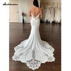 the back of a woman's wedding dress in a bridal gown shop room