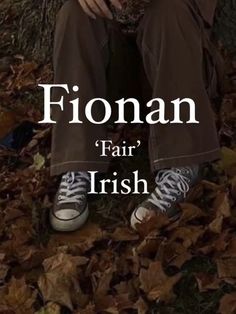 a man sitting on the ground with his hands in his pockets, and text that reads fionn fair irish