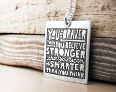 a square pendant with the words you're brave, may you believe stronger than you